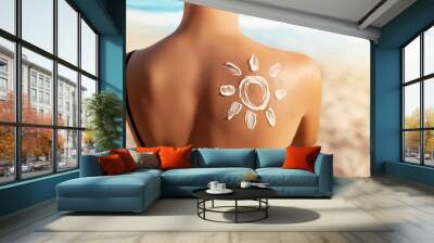 Sun Protection.Sun Cream. Woman Applying Sun Cream on Tanned  Shoulder In Form Of The Sun. Skin and Body Care. Girl Using Sunscreen to Skin. Wall mural