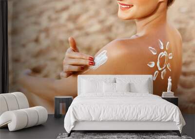 Woman applying sunscreen creme on  tanned  shoulder. Skincare. Body Sun protection suncream. Bikini hat woman applying moisturizing sunscreen lotion on back. Wall mural