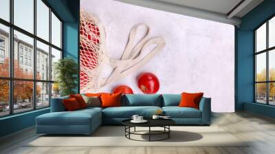 Large raw red tomatoes in a mesh bag Wall mural