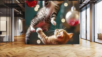 Two adorable kittens, one orange and one black, are playfully engaging with a variety of colorful christmas baubles in a festive holiday setting, creating a heartwarming and joyful scene. Wall mural