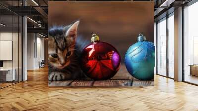 Two adorable kittens, one orange and one black, are playfully engaging with a variety of colorful christmas baubles in a festive holiday setting, creating a heartwarming and joyful scene. Wall mural