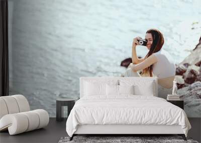 Beautiful happy woman with dreadlocks taking photos with vintage retro film camera Wall mural