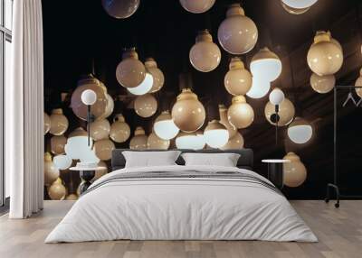 Light bulbs on dark background. Glowing lights Wall mural