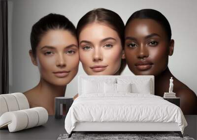 Beauty portrait of a diverse group of beautiful women posing together against a light grey studio background. Wall mural