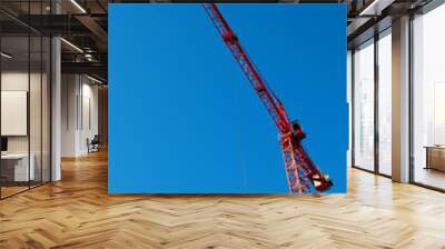 red construction tower crane with blue sky Wall mural