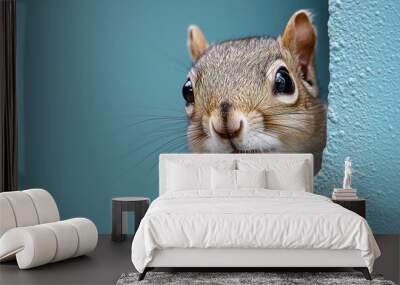 A cute squirrel peeks around a corner with a curious expression. Wall mural