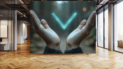 A pair of hands holds a glowing blue checkmark in a blurry forest background. Wall mural