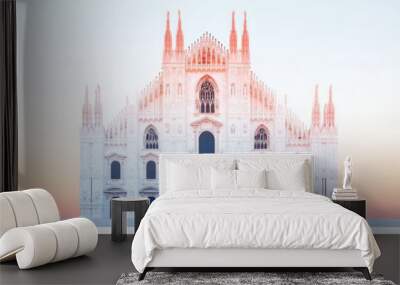 A white cathedral with a pink and orange sunset sky in the background. Wall mural