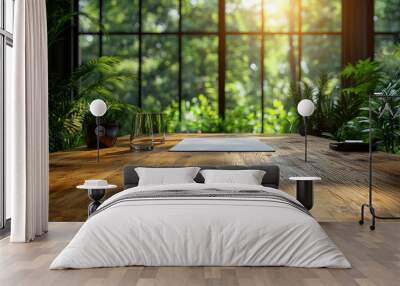 A wooden desk with a blank sheet of paper in front of a window with a green view. Wall mural