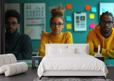 Multiracial male and female colleagues discussing business plan during meeting in creative office Wall mural