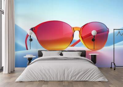 Red sunglasses with a gradient lens, resting on a white surface. Wall mural