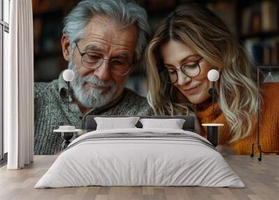 Senior couple looking at a tablet together. Wall mural