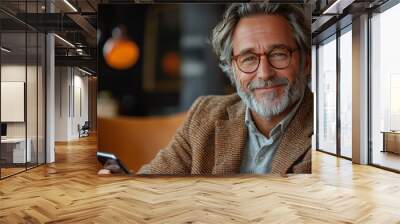 Smiling mature man using a phone. Wall mural