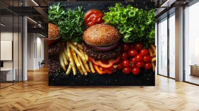 Two juicy burgers with toppings and sides, a delicious meal. Wall mural