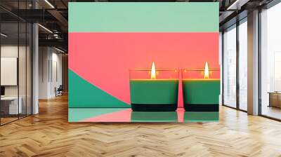 Two lit candles on a bright green and pink background. Wall mural