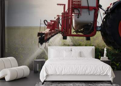 Tractor spraying pesticides at corn fields Wall mural