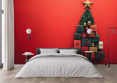 Christmas tree made of gift boxes and holiday ornaments on red background top view Wall mural