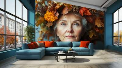 Serene elderly woman with wrinkles wearing autumn wreath, symbolizing nature s withering Wall mural