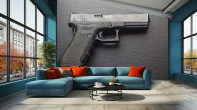 hand gun on black table  Wall mural