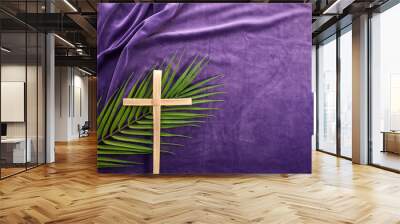 Lent season, Holy week and Good friday concept. Palm leave and cross on purple background Wall mural