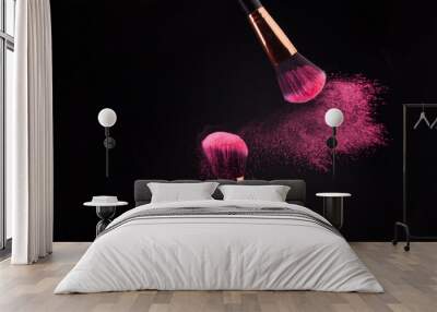 Make-up brush with colorful powder splashes explosion on black background Wall mural