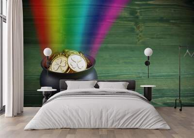 Pot Of Gold on green woden background. Magical Treasure with Rainbow Wall mural