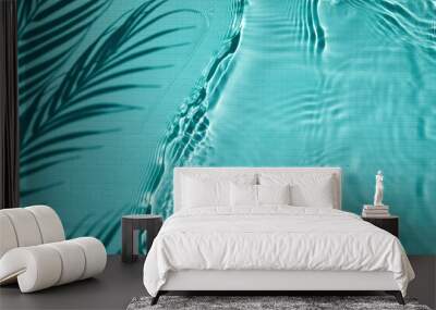 shadow of a palm tree on a blue water background Wall mural