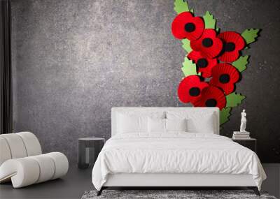 World War remembrance day. Red poppy is symbol of remembrance to those fallen in war. Red paper poppies on dark stone background Wall mural