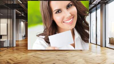 Businesswoman showing blank businesscard Wall mural