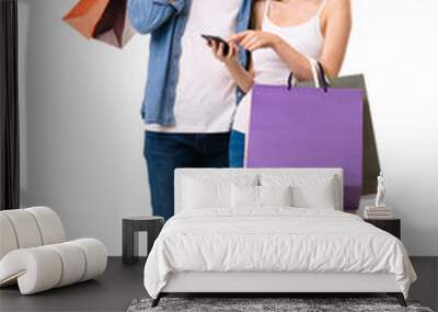 Couple with shopping bags and cellphone, on white Wall mural