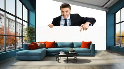 Happy businessman showing signboard, isolated Wall mural