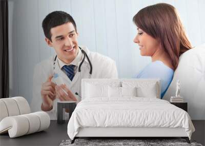 happy doctor with drug and patient on bed at clinic Wall mural