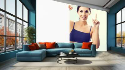 happy woman in fitnesswear showing signboard Wall mural