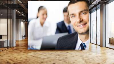 Portrait of happy smiling businessman and colleagues Wall mural