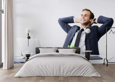 Relaxing or dreaming businessman at office Wall mural