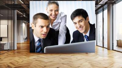 Three businesspeople working with laptop at office Wall mural