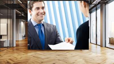 two businesspeople, or businessman and client working Wall mural