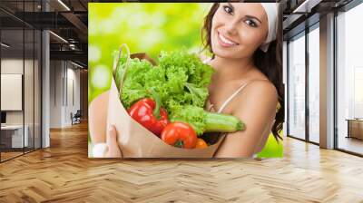 Woman in fitness wear with vegetarian food Wall mural