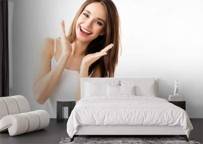 Young brunette lovely woman showing smile, in casual smart clothing, isolated against white background. Caucasian model in emoshions and optimistic, positive, happy feeling concept. Wall mural