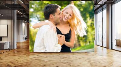 Young happy smiling couple walking outdoors together Wall mural