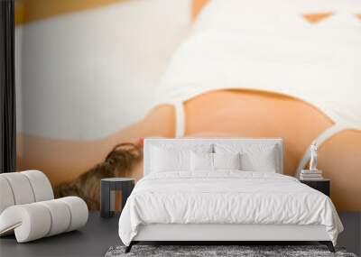 Young happy smiling woman waking up at bedroom Wall mural