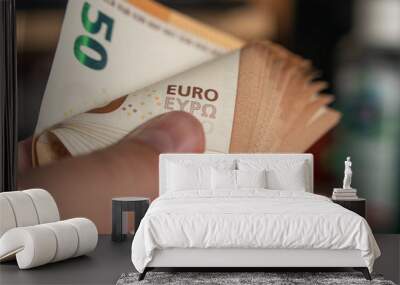 Bunch of Euro in the male hand background Wall mural