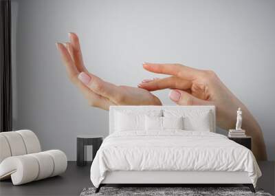 Spa and Manicure concept. Beautiful hands of a young girl with beautiful manicure on a gray background Wall mural