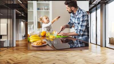 Adorable little girl giving father delicious cookie Wall mural