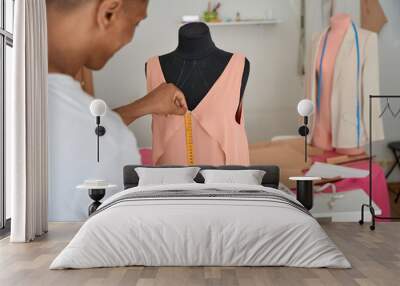 African American dressmaker measuring fabric on mannequin Wall mural