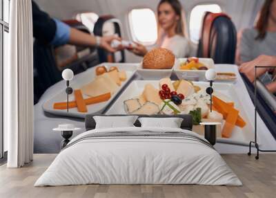 Airline meal for passengers standing on serving cart Wall mural