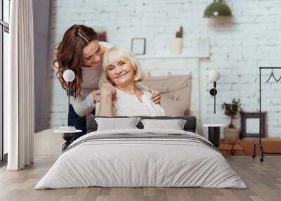 Cheerful elderly woman sittig in the wheelchair Wall mural