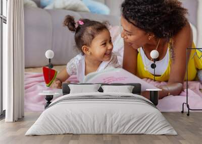 Cheerful young mother communicating with her daughter Wall mural