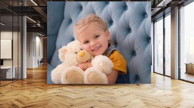 Cute innocent child hugging a teddy bear Wall mural