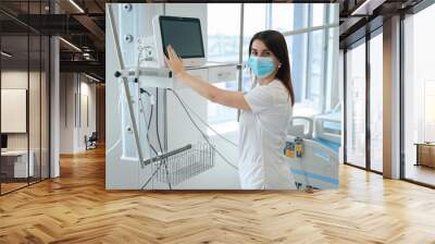 Female doctor control heart rate pulse on the monitor in intensive care unit Wall mural